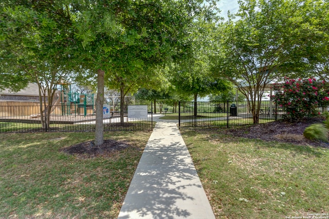 view of property's community featuring a playground and a lawn