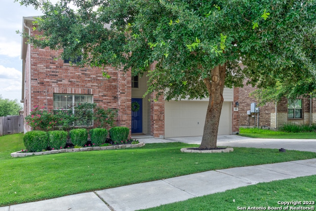 view of front of property featuring a garage and a front yard