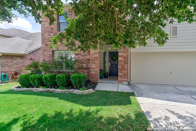 view of front of property with a garage and a front lawn