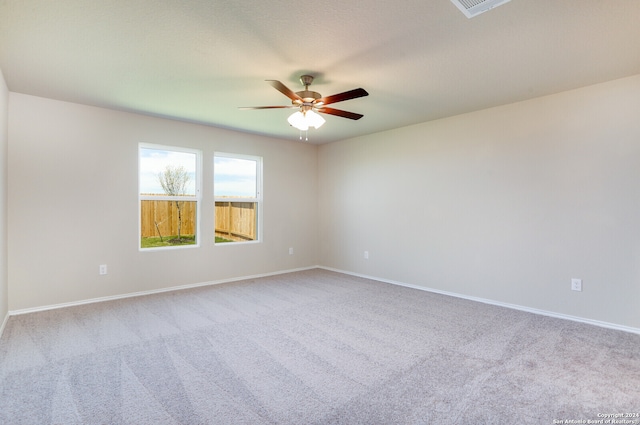 unfurnished room featuring light colored carpet and ceiling fan