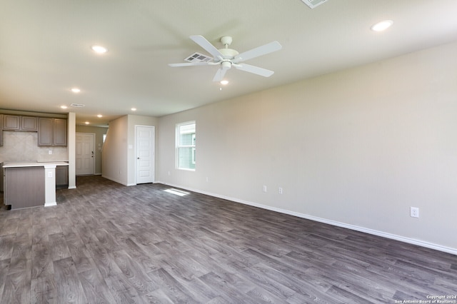 unfurnished living room with hardwood / wood-style flooring and ceiling fan