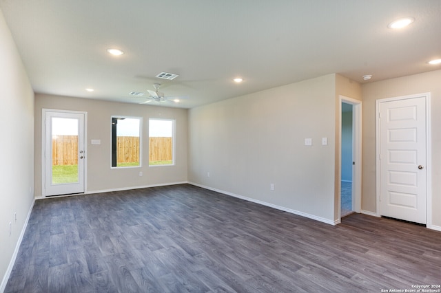 empty room with dark wood-type flooring and ceiling fan