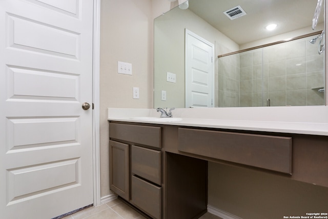 bathroom with vanity, tile patterned flooring, and a shower with shower door