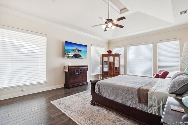 bedroom featuring dark hardwood / wood-style flooring, ornamental molding, and ceiling fan