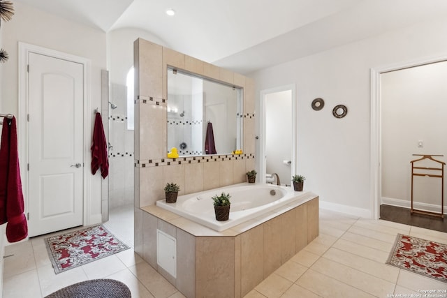 bathroom featuring independent shower and bath and tile patterned flooring