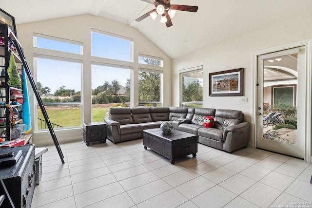 living room with ceiling fan, lofted ceiling, and light tile patterned flooring