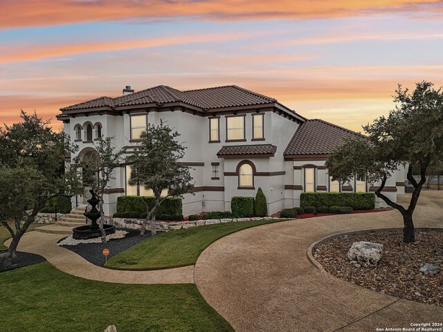 mediterranean / spanish-style house featuring a lawn