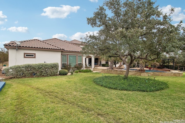 rear view of property with a patio area and a lawn