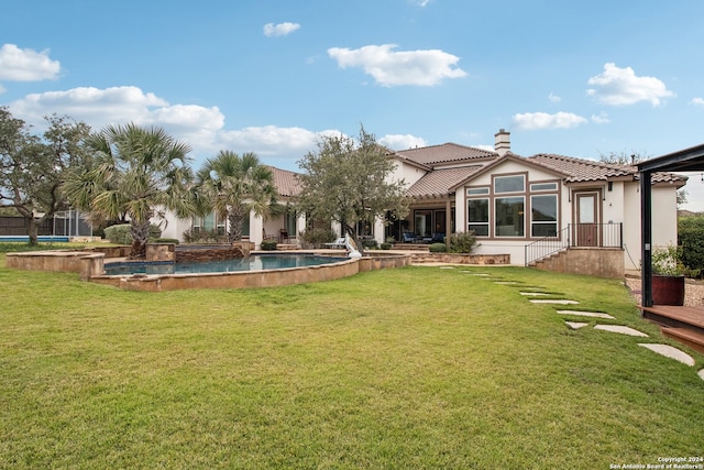 rear view of property featuring a yard