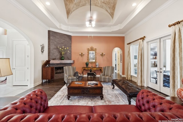 living room featuring french doors, hardwood / wood-style floors, ornamental molding, ceiling fan, and a tray ceiling