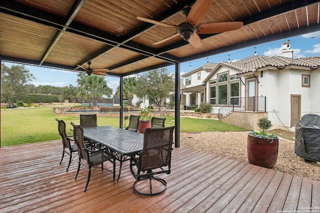 wooden deck featuring ceiling fan and a lawn