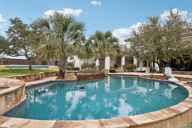 view of pool with an in ground hot tub