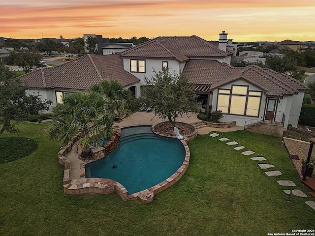 pool at dusk with a yard