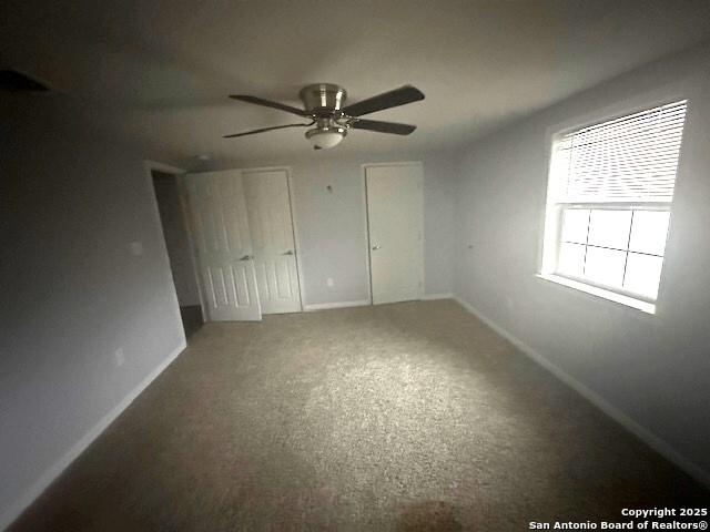 unfurnished bedroom with carpet floors and ceiling fan