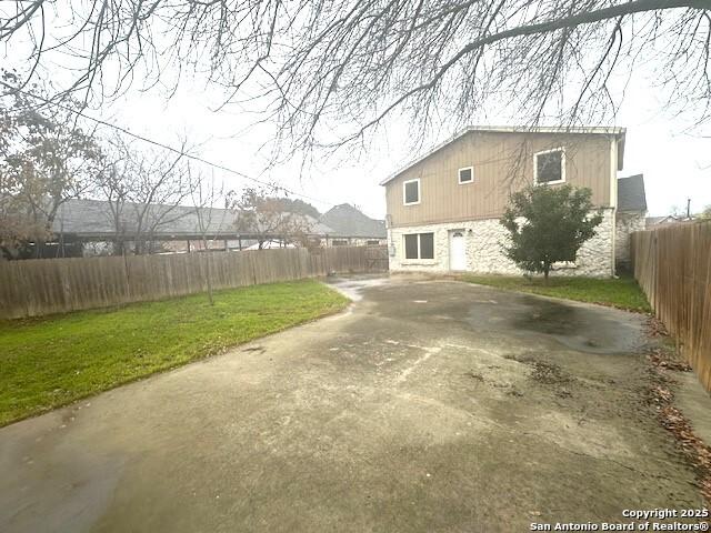 back of property featuring a lawn