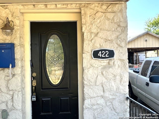 view of exterior entry with a garage