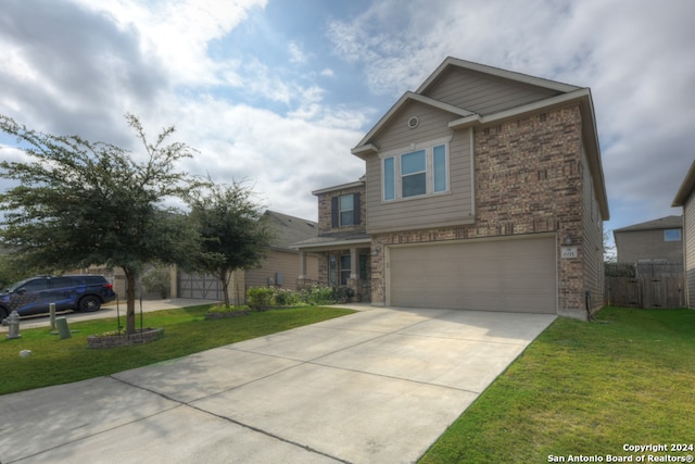 view of front of property with a garage and a front lawn