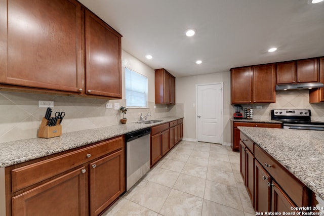 kitchen with stainless steel appliances, light stone counters, decorative backsplash, sink, and light tile patterned flooring