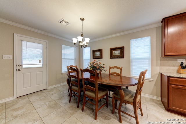 tiled dining room featuring a chandelier and crown molding