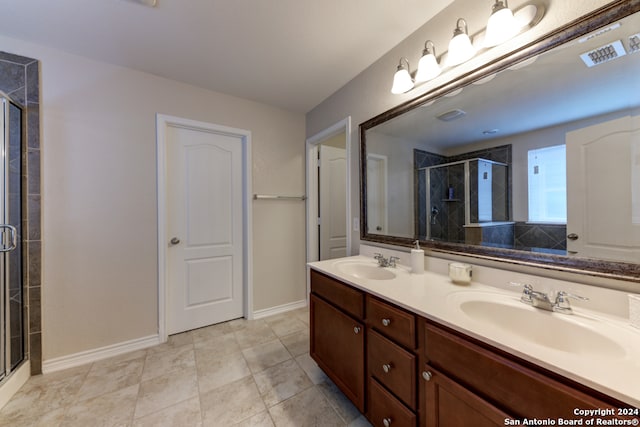 bathroom with tile patterned flooring, vanity, and an enclosed shower