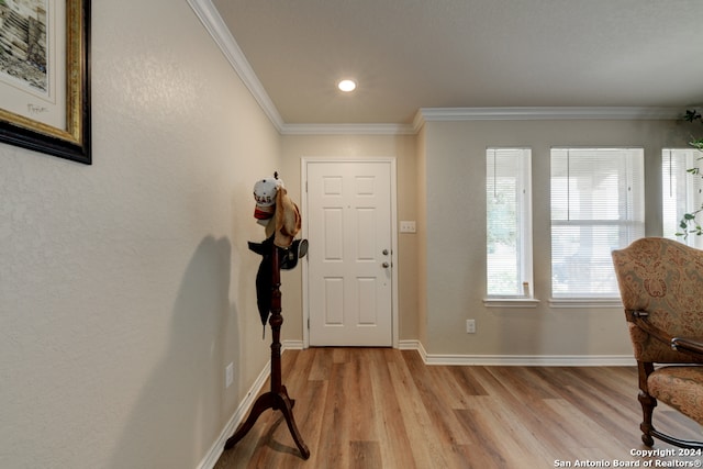 foyer featuring ornamental molding and light hardwood / wood-style floors