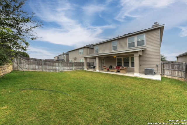 rear view of property with a patio area, a yard, and cooling unit