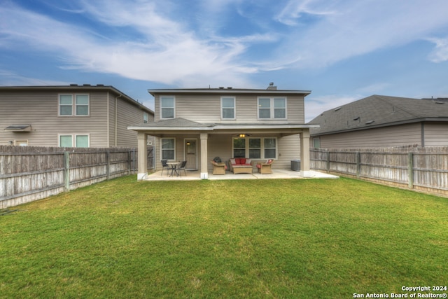 rear view of house featuring a patio area and a lawn