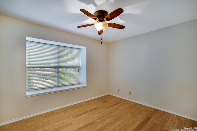 empty room with ceiling fan and light wood-type flooring