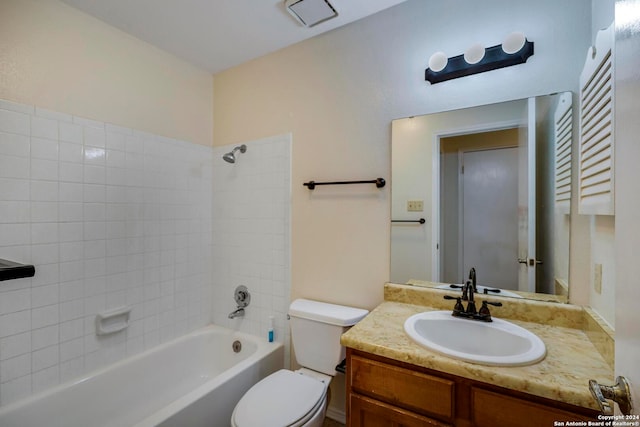 full bathroom with vanity, tiled shower / bath combo, and toilet