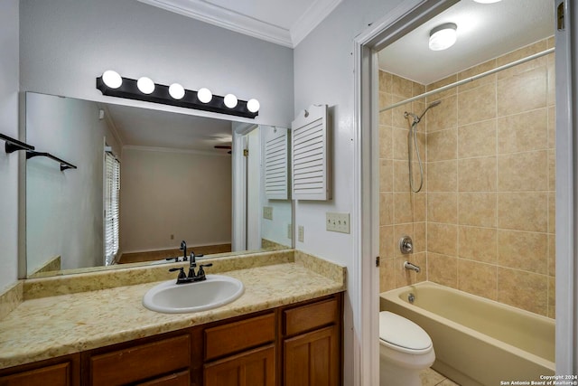 full bathroom featuring crown molding, vanity, toilet, and tiled shower / bath