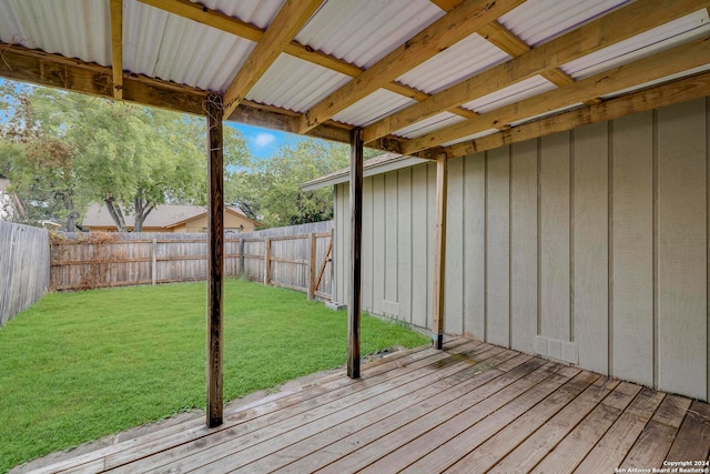 wooden terrace featuring a lawn