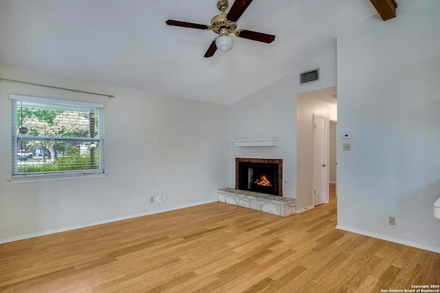 unfurnished living room featuring ceiling fan, light hardwood / wood-style floors, vaulted ceiling with beams, and a fireplace