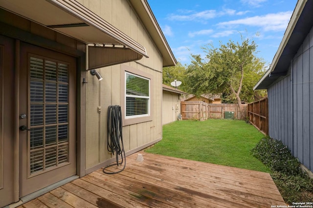 wooden deck featuring a yard