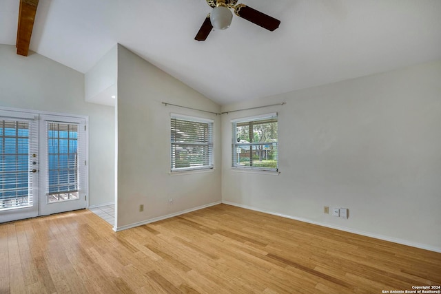 spare room with french doors, beam ceiling, high vaulted ceiling, light hardwood / wood-style floors, and ceiling fan