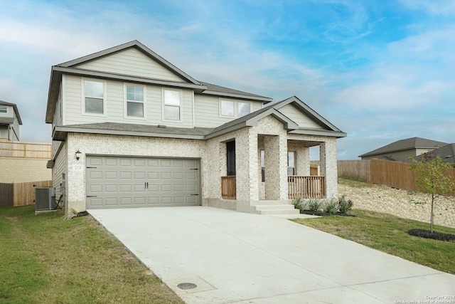 view of front of property with a garage, central AC unit, and a front lawn