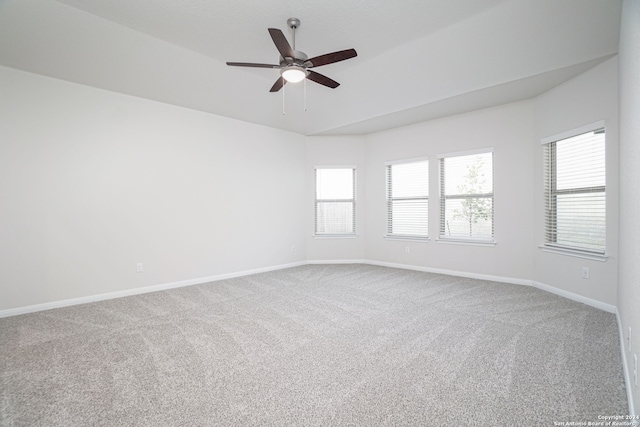 carpeted spare room featuring ceiling fan