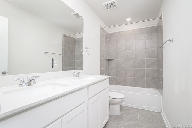 full bathroom featuring tile patterned floors, vanity, toilet, and tiled shower / bath combo