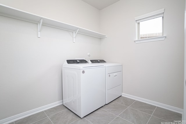 washroom with light tile patterned floors and independent washer and dryer