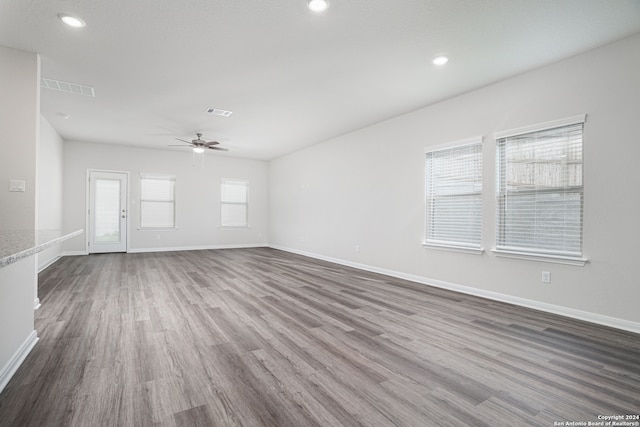 unfurnished room with hardwood / wood-style floors and ceiling fan