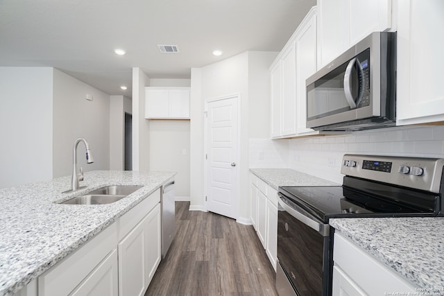 kitchen featuring dark wood-type flooring, white cabinetry, appliances with stainless steel finishes, and sink