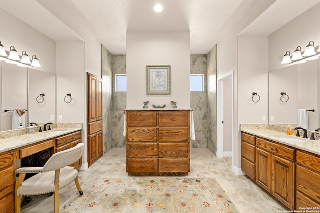 bathroom with vanity and tiled shower