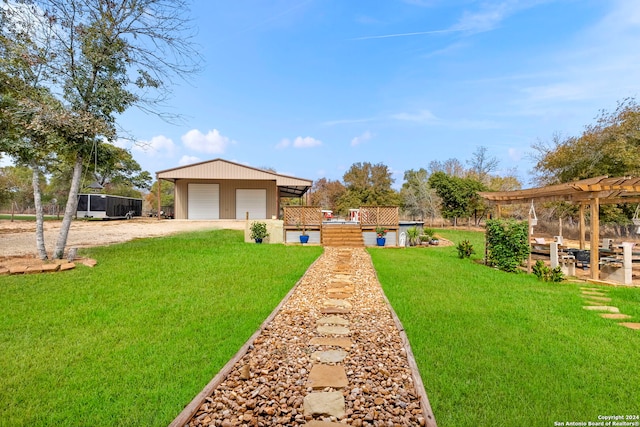 view of yard featuring a garage and an outdoor structure