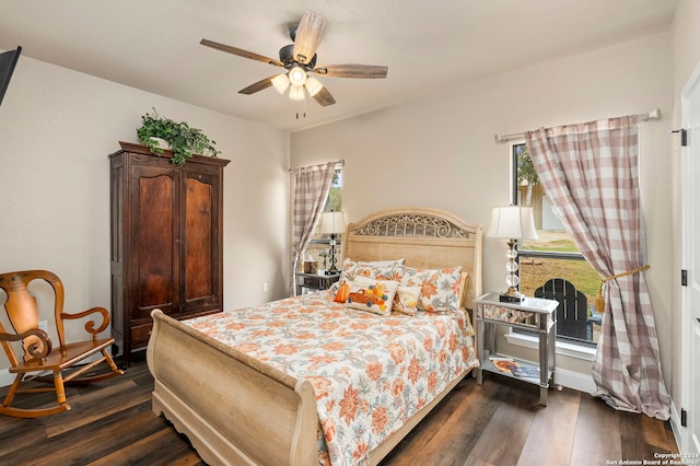 bedroom with dark wood-type flooring and ceiling fan