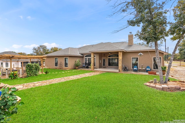 rear view of property with a lawn and a patio area