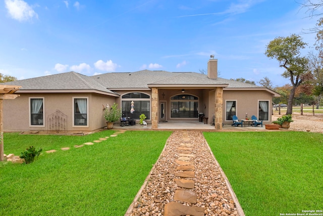 rear view of house featuring outdoor lounge area, a patio, and a yard