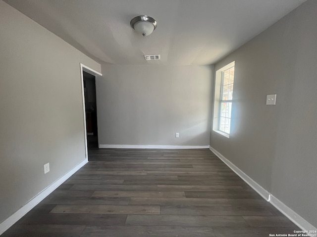 unfurnished room featuring dark hardwood / wood-style floors