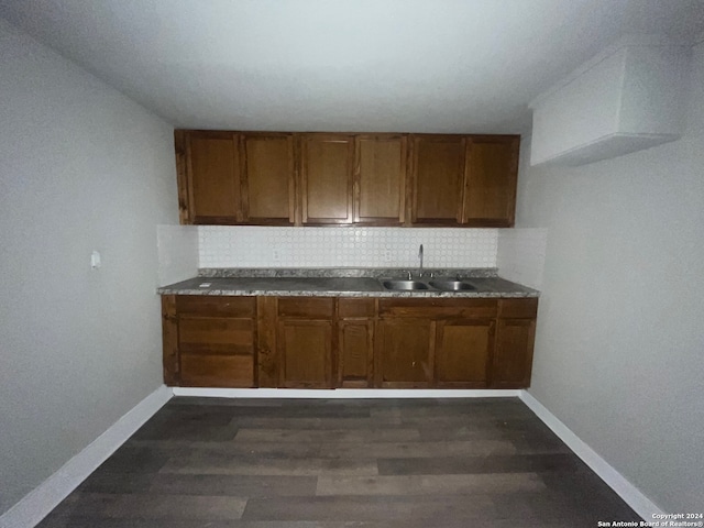 kitchen with sink, dark hardwood / wood-style floors, and backsplash