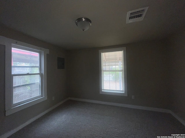 carpeted empty room featuring electric panel