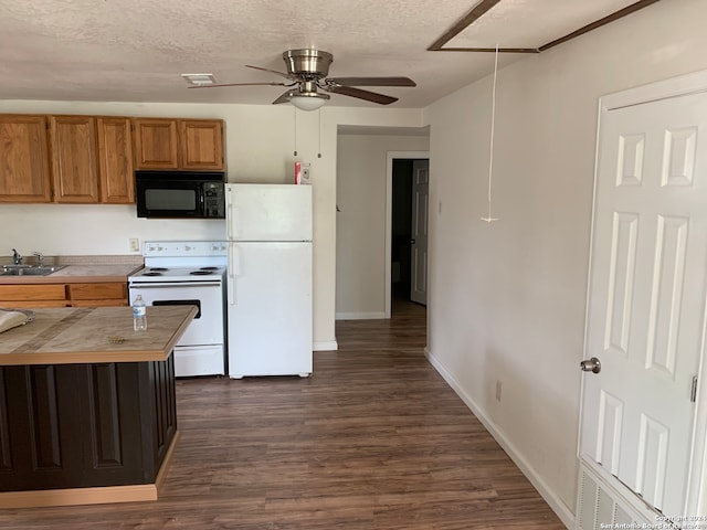 7007 Calle Aleman, San Antonio, TX 78252 - kitchen with a textured ceiling, white appliances, dark wood-type flooring, and sink