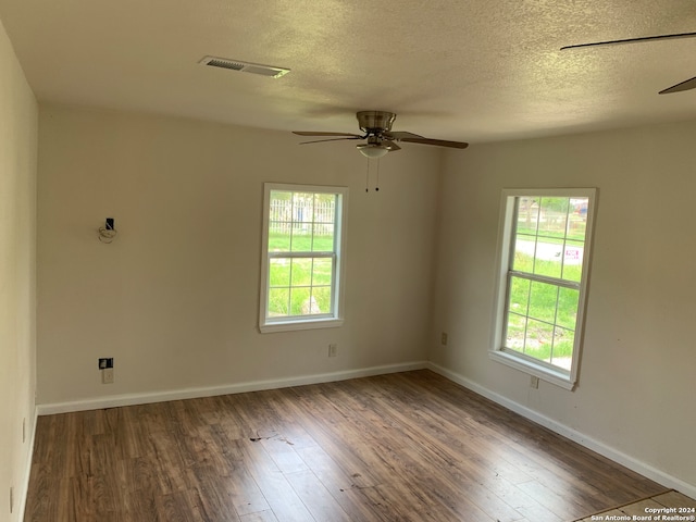 7007 Calle Aleman, San Antonio, TX 78252 - spare room featuring ceiling fan, a healthy amount of sunlight, and dark wood-type flooring